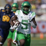 
              Oregon running back Sean Dollars (5) runs with the ball after a catch against California during the first half of an NCAA college football game in Berkeley, Calif., Saturday, Oct. 29, 2022. (AP Photo/Godofredo A. Vásquez)
            