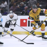 
              Vegas Golden Knights' Jack Eichel, right, shoots under pressure from Los Angeles Kings' Phillip Danault, foreground, and Viktor Arvidsson during the first period of an NHL hockey game Tuesday, Oct. 11, 2022, in Los Angeles. (AP Photo/Jae C. Hong)
            