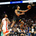 Phoenix Suns' Cameron Payne (15) goes to the basket as Houston Rockets' Josh Christopher (9) looks on during the second half of an NBA basketball game, Sunday, Oct. 30, 2022, in Phoenix. (AP Photo/Darryl Webb)