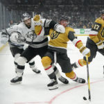 Vegas Golden Knights' Jack Eichel, center right, loses balance while being pressured by Los Angeles Kings' Phillip Danault during the second period of an NHL hockey game Tuesday, Oct. 11, 2022, in Los Angeles. (AP Photo/Jae C. Hong)