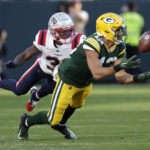 Green Bay Packers wide receiver Allen Lazard catches a pass ahead of New England Patriots cornerback Jonathan Jones, left, during the second half of an NFL football game, Sunday, Oct. 2, 2022, in Green Bay, Wis. (AP Photo/Matt Ludtke)