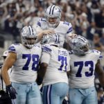 
              Dallas Cowboys quarterback Cooper Rush celebrates throwing a touchdown pass with Terence Steele (78), Jason Peters (71), and Tyler Smith (73) in the second half of a NFL football game against the Washington Commanders in Arlington, Texas, Sunday, Oct. 2, 2022. (AP Photo/Michael Ainsworth)
            