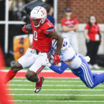 
              Liberty running back Dae Dae Hunter, left, protects the ball from BYU's Kaleb Hayes during an NCAA college football game, Saturday, Oct. 22, 2022, in Lynchburg, Va. (Paige Dingler/The News & Advance via AP)
            