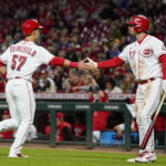 
              Cincinnati Reds' Stuart Fairchild (57) celebrates with Kyle Farmer (17) after scoring on a Jonathan India ground-rule double during the eighth inning of a baseball game against the Chicago Cubs, Monday, Oct. 3, 2022, in Cincinnati. (AP Photo/Jeff Dean)
            