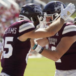 Mississippi State wide receiver Austin Williams (85) celebrates his 10-yard pass reception with quarterback Will Rogers (2) during the first half of an NCAA college football game against Arkansas in Starkville, Miss., Saturday, Oct. 8, 2022. (AP Photo/Rogelio V. Solis)