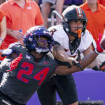 TCU cornerback Josh Newton (24) deflects a pass intended for Oklahoma State wide receiver Braydon Johnson (8) during the first half of an NCAA college football game in Fort Worth, Texas, Saturday, Oct. 15, 2022. (AP Photo/Sam Hodde)