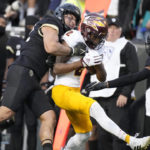 Arizona State wide receiver Elijhah Badger, center, is tackled by Colorado linebacker Quinn Perry, left, and safety Tyrin Taylor after pulling in a pass in the first half of an NCAA college football game Saturday, Oct. 29, 2022, in Boulder, Colo. (AP Photo/David Zalubowski)