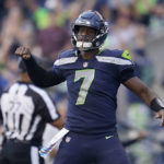 Seattle Seahawks quarterback Geno Smith (7) celebrates a touchdown run by running back Kenneth Walker III during the second half of an NFL football game against the Arizona Cardinals in Seattle, Sunday, Oct. 16, 2022. (AP Photo/Abbie Parr)