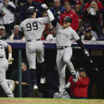 
              New York Yankees' Oswaldo Cabrera (95), Aaron Judge (99) and Anthony Rizzo, right, celebrate after Judge's home run against the Cleveland Guardians during the third inning of Game 3 of a baseball AL Division Series, Saturday, Oct. 15, 2022, in Cleveland. (AP Photo/Phil Long)
            