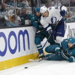 San Jose Sharks left wing Matt Nieto, left, and center Logan Couture battle for the puck against the Tampa Bay Lightning defenseman Cal Foote, in the first period of an NHL hockey game, Saturday, Oct. 29, 2022, in San Jose, Calif., Saturday, Oct. 29, 2022. (AP Photo/Josie Lepe)