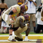 Arizona State running back Daniyel Ngata (4) celebrates his touchdown against Washington with Arizona State offensive lineman Ben Scott (66) during the second half of an NCAA college football game in Tempe, Ariz., Saturday, Oct. 8, 2022. (AP Photo/Ross D. Franklin)