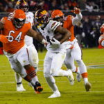 
              Washington Commanders running back Antonio Gibson is chased by Chicago Bears defensive lineman Mike Pennel Jr. in the second half of an NFL football game in Chicago, Thursday, Oct. 13, 2022. (AP Photo/Charles Rex Arbogast)
            