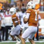 
              Texas quarterback Hudson Card (1) looks for a receiver during the first half of the team's NCAA college football game against West Virginia on Saturday, Oct. 1, 2022, in Austin, Texas. (AP Photo/Stephen Spillman)
            