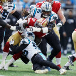 San Francisco 49ers running back Tevin Coleman is tackled by Carolina Panthers defensive tackle Derrick Brown and linebacker Cory Littleton during the first half an NFL football game on Sunday, Oct. 9, 2022, in Charlotte, N.C. (AP Photo/Rusty Jones)