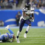 
              Seattle Seahawks wide receiver DK Metcalf pulls away from Detroit Lions cornerback Jeff Okudah during the first half of an NFL football game, Sunday, Oct. 2, 2022, in Detroit. (AP Photo/Paul Sancya)
            