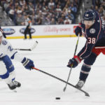 Tampa Bay Lightning's Brayden Point, left, tries to block a shot by Columbus Blue Jackets' Boone Jenner during the second period of an NHL hockey game Friday, Oct. 14, 2022, in Columbus, Ohio. (AP Photo/Jay LaPrete)