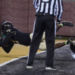 Wake Forest's A.T. Perry (9) falls out of the end zone after making a touchdown catch against Army during the second half of an NCAA college football game in Winston-Salem, N.C., Saturday, Oct. 8, 2022. (AP Photo/Chuck Burton)