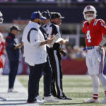 
              New England Patriots quarterback Bailey Zappe (4) speaks with Patriots senior football advisor/offensive line Matt Patricia, center left, during the first half of an NFL football game against the Detroit Lions, Sunday, Oct. 9, 2022, in Foxborough, Mass. (AP Photo/Michael Dwyer)
            