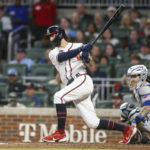 Atlanta Braves' Dansby Swanson follows through on a single during the third inning of the team's baseball game against the New York Mets, Saturday, Oct. 1, 2022, in Atlanta. (AP Photo/Brett Davis)