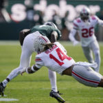 
              Ohio State safety Ronnie Hickman (14) deflects a pass intended for Michigan State wide receiver Jayden Reed during the first half of an NCAA college football game, Saturday, Oct. 8, 2022, in East Lansing, Mich. (AP Photo/Carlos Osorio)
            