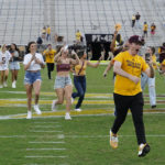 Arizona State students run on the field after an NCAA college football game against Washington in Tempe, Ariz., Saturday, Oct. 8, 2022. (AP Photo/Ross D. Franklin)