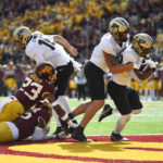 
              Purdue running back Dylan Downing, right, runs into the end zone for a touchdown, with the help of tight end Payne Durham, during the first half an NCAA college football game against Minnesota on Saturday, Oct. 1, 2022, in Minneapolis. (AP Photo/Craig Lassig)
            