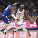 Oklahoma City Thunder forward Luguentz Dort (5) pushes past Los Angeles Clippers forward Terance Mann (14) in the first half of an NBA basketball game, Thursday, Oct. 27, 2022, in Oklahoma City. (AP Photo/Kyle Phillips)