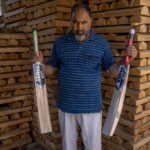 
              Javid Ahmed, owner of a cricket bat factory displays his finished bats in Awantipora, in Srinagar, Indian controlled Kashmir, Sept. 22, 2022. Kashmir’s dwindling willow plantations are impacting the region’s famed cricket bat industry and risking the supply of cricket bats in India, where the sport is hugely followed. The industry employs more than 10,000 people and manufactures nearly a million bats a year. (AP Photo/Dar Yasin)
            