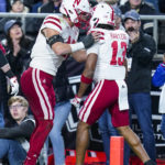 Nebraska defensive back Malcolm Hartzog (13) celebrates an interception with linebacker Nick Henrich (42) during the first half of an NCAA college football game against Purdue in West Lafayette, Ind., Saturday, Oct. 15, 2022. (AP Photo/Michael Conroy)