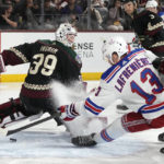 New York Rangers left wing Alexis Lafreniere (13) scores a goal against Arizona Coyotes goaltender Connor Ingram (39) during the second period of an NHL hockey game at Mullett Arena in Tempe, Ariz., Sunday, Oct. 30, 2022. (AP Photo/Ross D. Franklin)