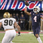 Arizona wide receiver Tetairoa McMillan (4) throws a pass over Colorado defensive end Chance Main (90) during the first half of an NCAA college football game Saturday, Oct. 1, 2022, in Tucson, Ariz. (AP Photo/Rick Scuteri)