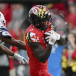 Maryland wide receiver Rakim Jarrett makes a reception for a touchdown against Northwestern defensive back Rod Heard II during the second half of an NCAA college football game Saturday, Oct. 22, 2022, in College Park, Md. (AP Photo/Gail Burton)