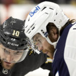
              Vegas Golden Knights center Nicolas Roy (10) faces off against Winnipeg Jets center Adam Lowry, right, during the second period in an NHL hockey game, Sunday, Oct. 30, 2022, in Las Vegas. (AP Photo/Ellen Schmidt)
            