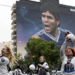 Women play with balls during the inauguration of a mural of Diego Maradona by artist Martin Ron in Buenos Aires, Argentina, Sunday, Oct. 30, 2022. Sunday marks the birth date of Maradona who died on Nov. 25, 2020 at the age of 60.(AP Photo/Rodrigo Abd)