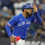 Toronto Blue Jays' Teoscar Hernandez heads to first base after being hit by a Seattle Mariners pitch with the bases loaded during the fifth inning of Game 2 of a baseball AL wild-card playoff series Saturday, Oct. 8, 2022, in Toronto. (Frank Gunn/The Canadian Press via AP)