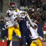 Southern California defensive back Calen Bullock (7) and defensive back Max Williams (4) break up the pass intended for Arizona wide receiver Tetairoa McMillan (4) in the second half during an NCAA college football game, Saturday, Oct. 29, 2022, in Tucson, Ariz. (AP Photo/Rick Scuteri)