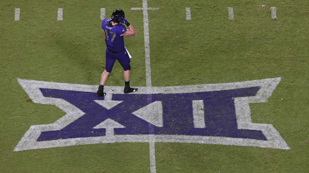 TCU tight end Carter Ware (47) walks across a Big 12 Conference logo as TCU plays Duquesne during t...