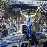 
              Chase Elliott celebrates in Victory Lane after winning a NASCAR Cup Series auto race Sunday, Oct. 2, 2022, in Talladega, Ala. (AP Photo/Butch Dill)
            
