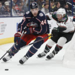 Columbus Blue Jackets' Erik Gudbranson, left, looks for an open pass as Arizona Coyotes' Travis Boyd chases him during the first period of an NHL hockey game Tuesday, Oct. 25, 2022, in Columbus, Ohio. (AP Photo/Jay LaPrete)