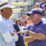 Mississippi head coach Lane Kiffin, left, talks with LSU head coach Brian Kelly before an NCAA college football game in Baton Rouge, La., Saturday, Oct. 22, 2022. (AP Photo/Matthew Hinton)