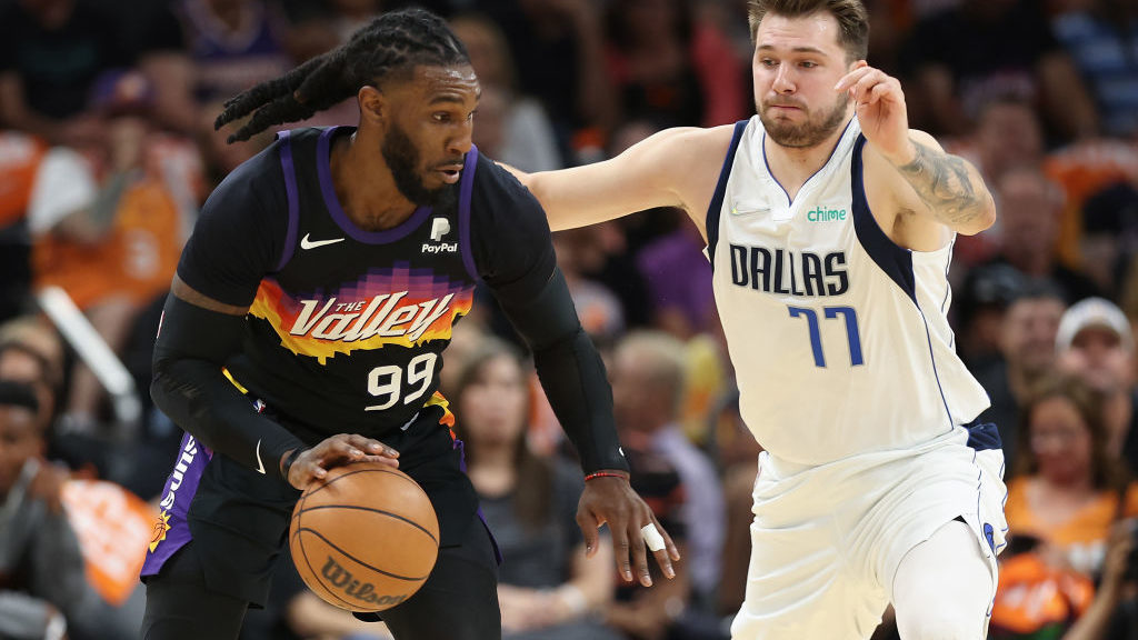 Jae Crowder #99 of the Phoenix Suns handles the ball against Luka Doncic #77 of the Dallas Maverick...
