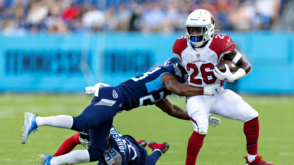 Eno Benjamin #26 of the Arizona Cardinals runs the ball and is knocked out of bounds during a prese...
