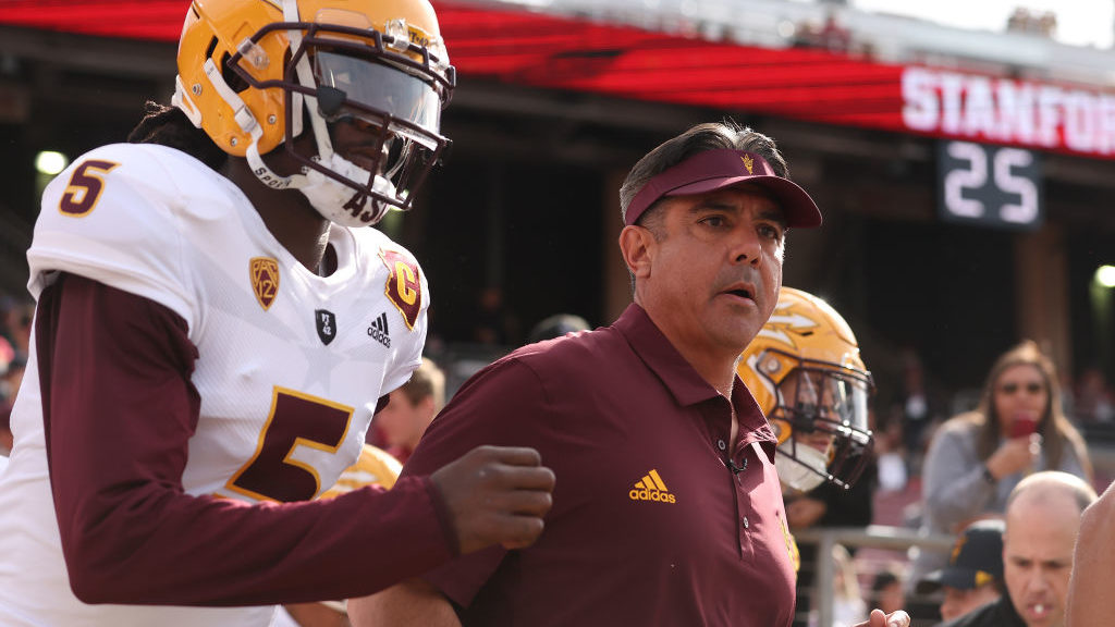 Head coach Shaun Aguano of the Arizona State Sun Devils runs out with the team before the game agai...