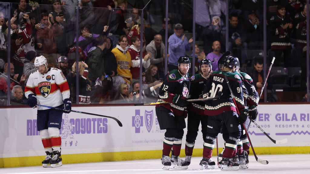 Nick Ritchie #12 of the Arizona Coyotes celebrates with Clayton Keller #9, J.J. Moser #90 and Travi...