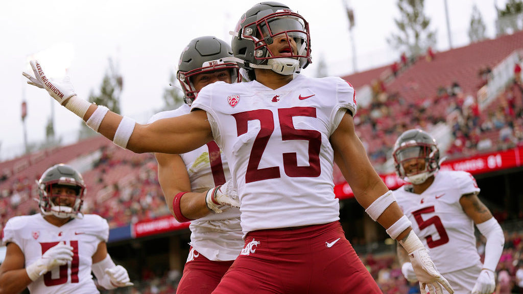 Jaden Hicks #25 of the Washington State Cougars celebrates after he returned a fumble for a touchdo...
