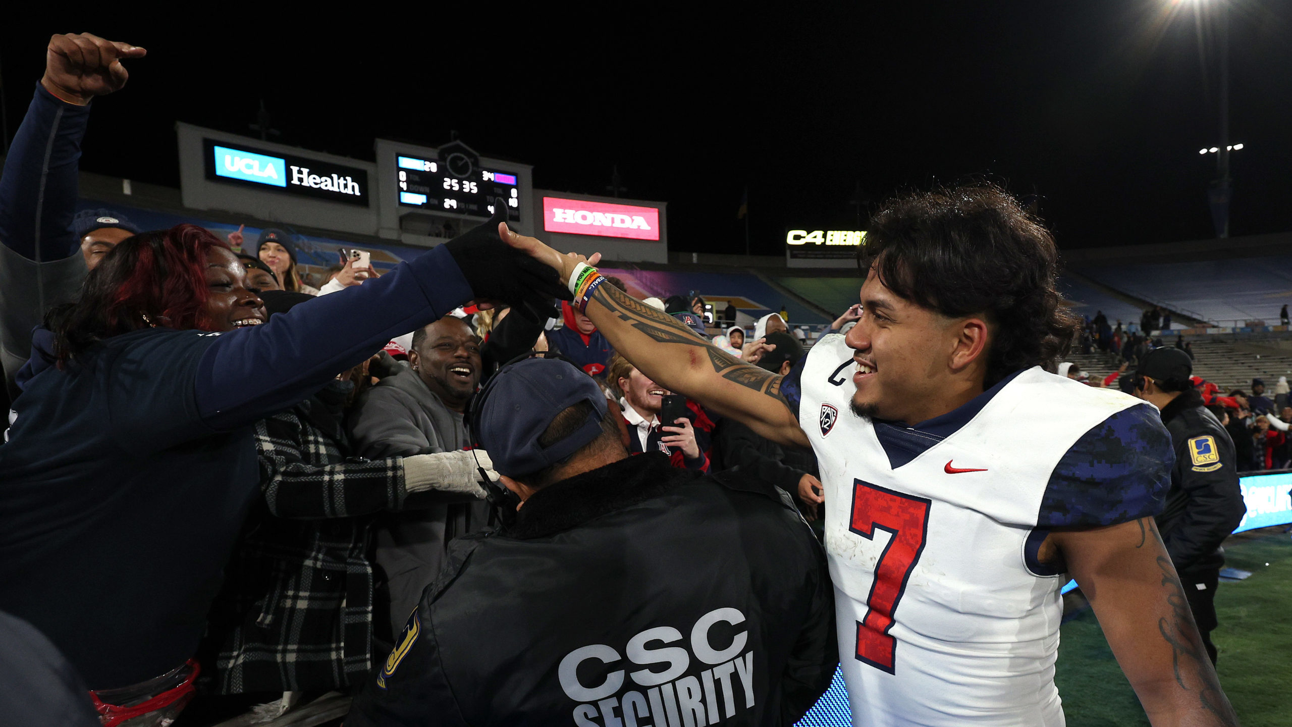 Jayden de Laura #7 of the Arizona Wildcats celebrates a 31-28 win over the UCLA Bruins with fans at...