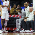 
              Philadelphia 76ers' Tyrese Maxey, center, looks on from the bench with a foot fracture during the first half of an NBA basketball game against the Minnesota Timberwolves, Saturday, Nov. 19, 2022, in Philadelphia. (AP Photo/Chris Szagola)
            