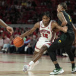 Houston guard Tramon Mark (12) drives the lane past Norfolk State forward Nyzaiah Chambers (1) during the second half of an NCAA college basketball game, Tuesday, Nov. 29, 2022, in Houston. (AP Photo/Kevin M. Cox)