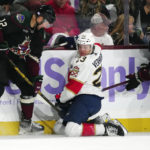 Arizona Coyotes left wing Nick Ritchie (12) and center Barrett Hayton (29) try to get the puck from underneath Florida Panthers center Carter Verhaeghe (23) during the third period of an NHL hockey game in Tempe, Ariz., Tuesday, Nov. 1, 2022. The Coyotes won 3-1. (AP Photo/Ross D. Franklin)
