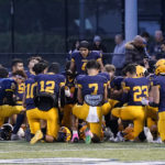 
              Dearborn Fordson High School receiver Hassan Shinawah leads the team in prayer before its game against Dearborn High School, Friday, Oct. 14, 2022 in Dearborn, Mich. (AP Photo/Carlos Osorio)
            